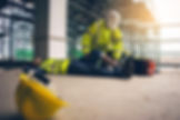 Man carrying out first aid on injured worker