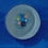 Thumbnail: Seven Marbles In A Blue Rimmed Bowl On A Blue Napkin