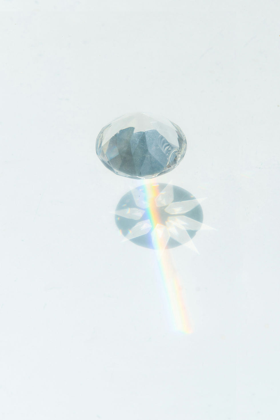 Crystal prism reflecting a rainbow for clarity coaching
