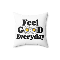 Plush blue pillow expressing kindness and being held by a woman in a comfortable chair