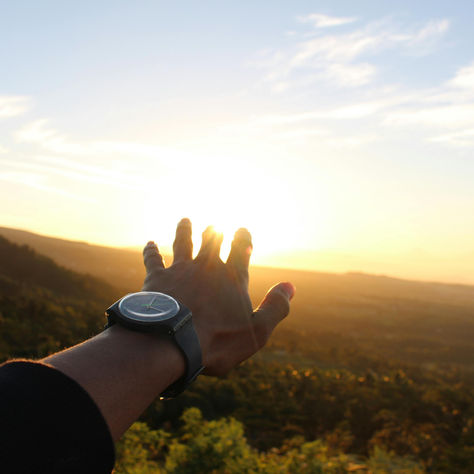 Man's arm reaching for the sunrise - https://www.pexels.com/@debby-anggraeni-499876/