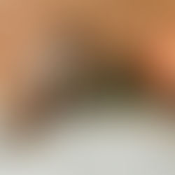 Guy smiling and vibing in bed while listening to his headphones