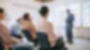 male-speaker-giving-presentation-hall-un