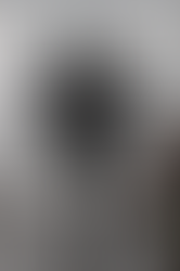 A black model wearing a black two-piece swimsuit and a large black spikey costume piece on her back, from the Maximilian Davis Spring 2022 runway show at London Fashion Week