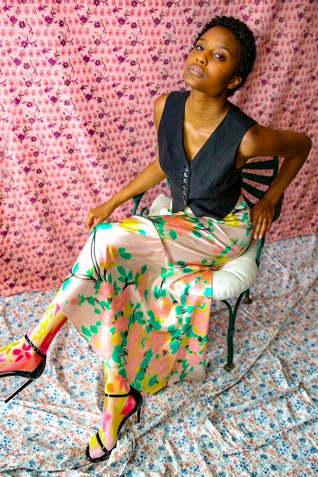 Woman wearing black vest and floral printed maxi skirt from the Hope for Flowers collection by Tracy Reese