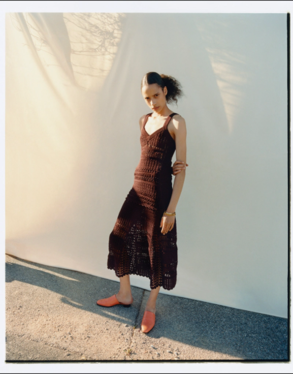 A female model outside posing in a brown crochet maxi dress from the Wales Bonner Spring 2022 collection