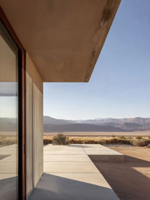 Desert home architectural visualization with minimalist concrete structure and mountain backdrop, by Atelier Aida