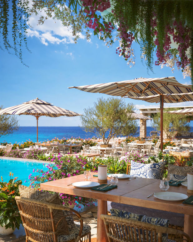 Santa Marina Hotel, Mykonos – beachfront terrace with parasols and a pool overlooking the turquoise sea