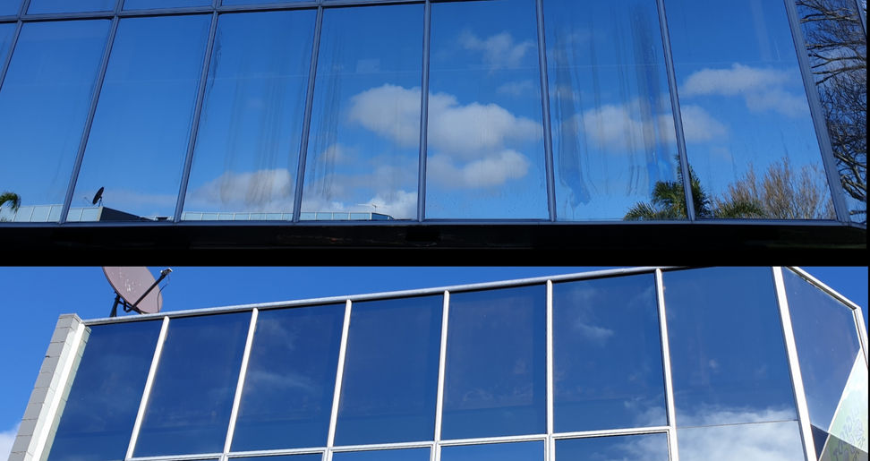 Modern glass building reflecting blue sky and clouds, window light, architectural design.