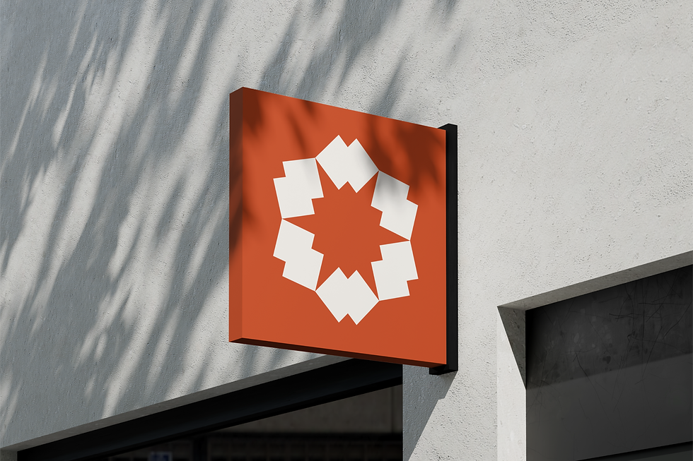 Kennith Infraventures exterior signage mockup featuring branded geometric logo on a terracotta background for architectural identity.
