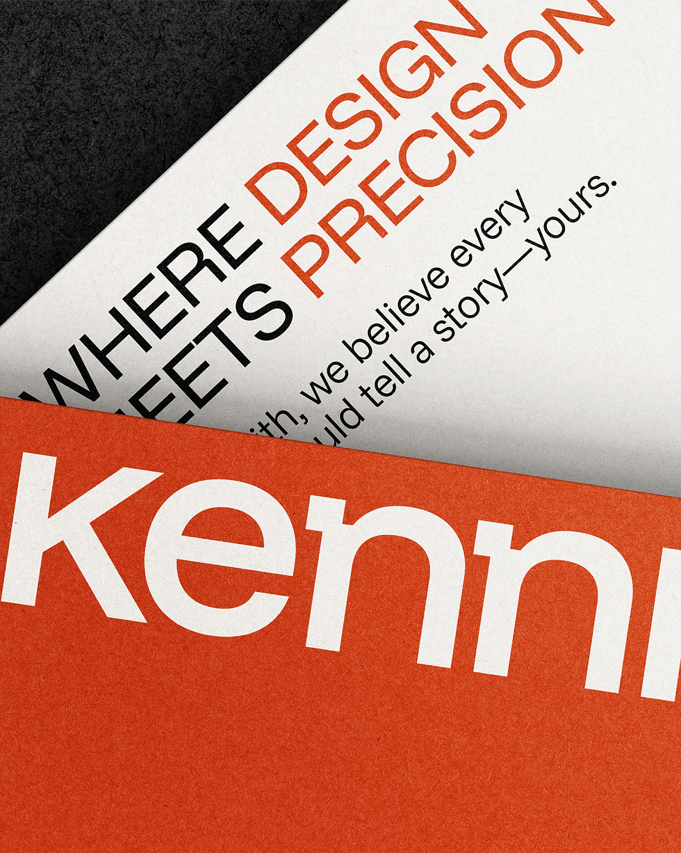 Kennith Infraventures brand stationery close-up highlighting tagline ‘Where Design Meets Precision’ in signature orange and black colors.