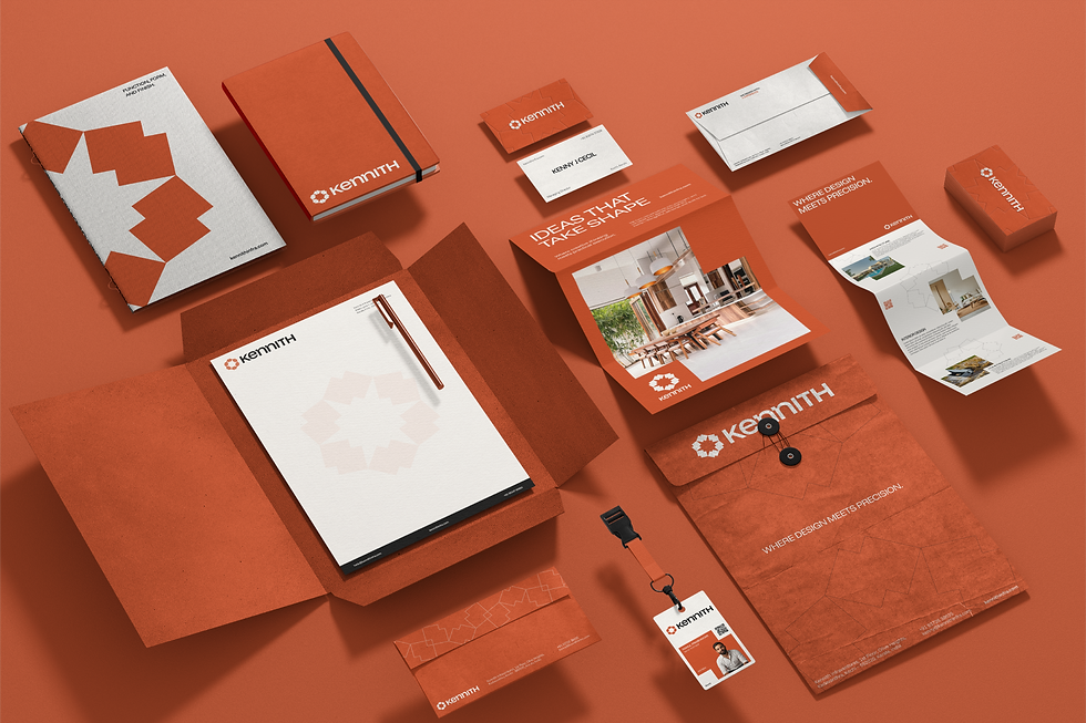 A flat lay of branded Kennith stationery and office supplies including folders, notebooks, business cards, letterhead, brochures, envelopes, a lanyard, and a branded pouch. Most items are in shades of terracotta with white geometric motifs, underscoring a cohesive, modern brand identity.