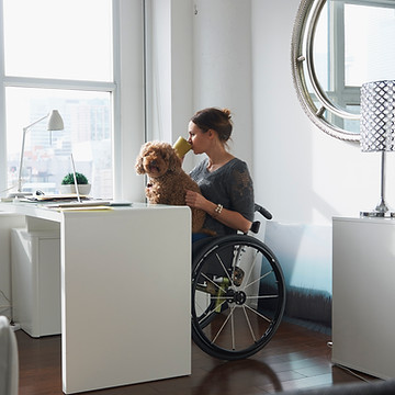 Woman in Wheelchair Drinking Coffee