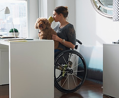 Woman in Wheelchair Drinking Coffee