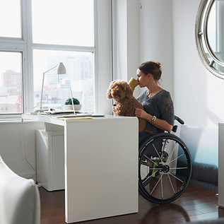 Woman in Wheelchair Drinking Coffee