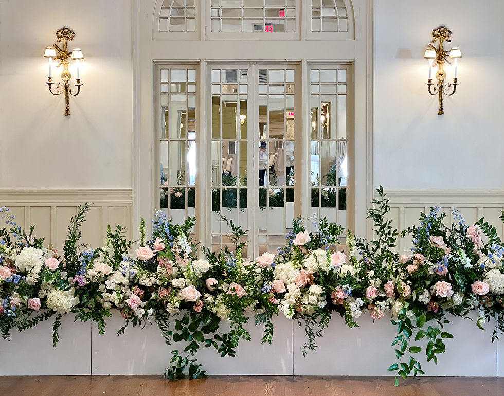 Elegant wedding reception at New Orleans Country Club with stage front florals by Leaf + Petal.