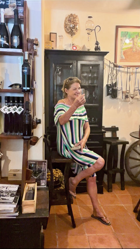 A lady enjoying homemade liqueurs in a family-run winery on the Pelješac Peninsula