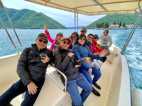 Guests enjoying boat ride in Perast