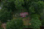 Overhead aerial view of an outdoor event surrounded by trees