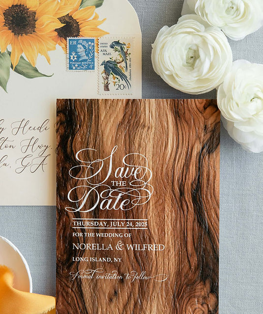 Wood grain save-the-date and sunflower envelope for Norella and Wilfred's Rustic Long Island wedding.