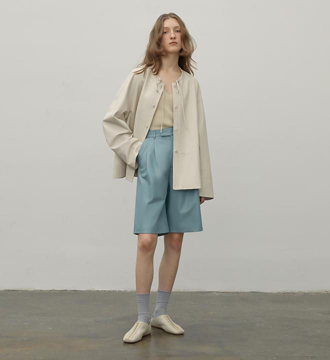 Thumbnail: Ivory Jacket front view styled with denim shorts