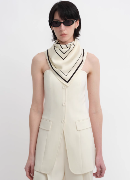Thumbnail: geometric printed cream silk scarf styled around the neck front view