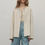 Thumbnail: Ivory Jacket front view styled with denim shorts