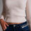 Thumbnail: ribbed white sweetheart neckline top waist close up view