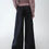 Thumbnail: Flat lay of pleated wide-leg tailored denim, back view showing clean lines and structured back pockets