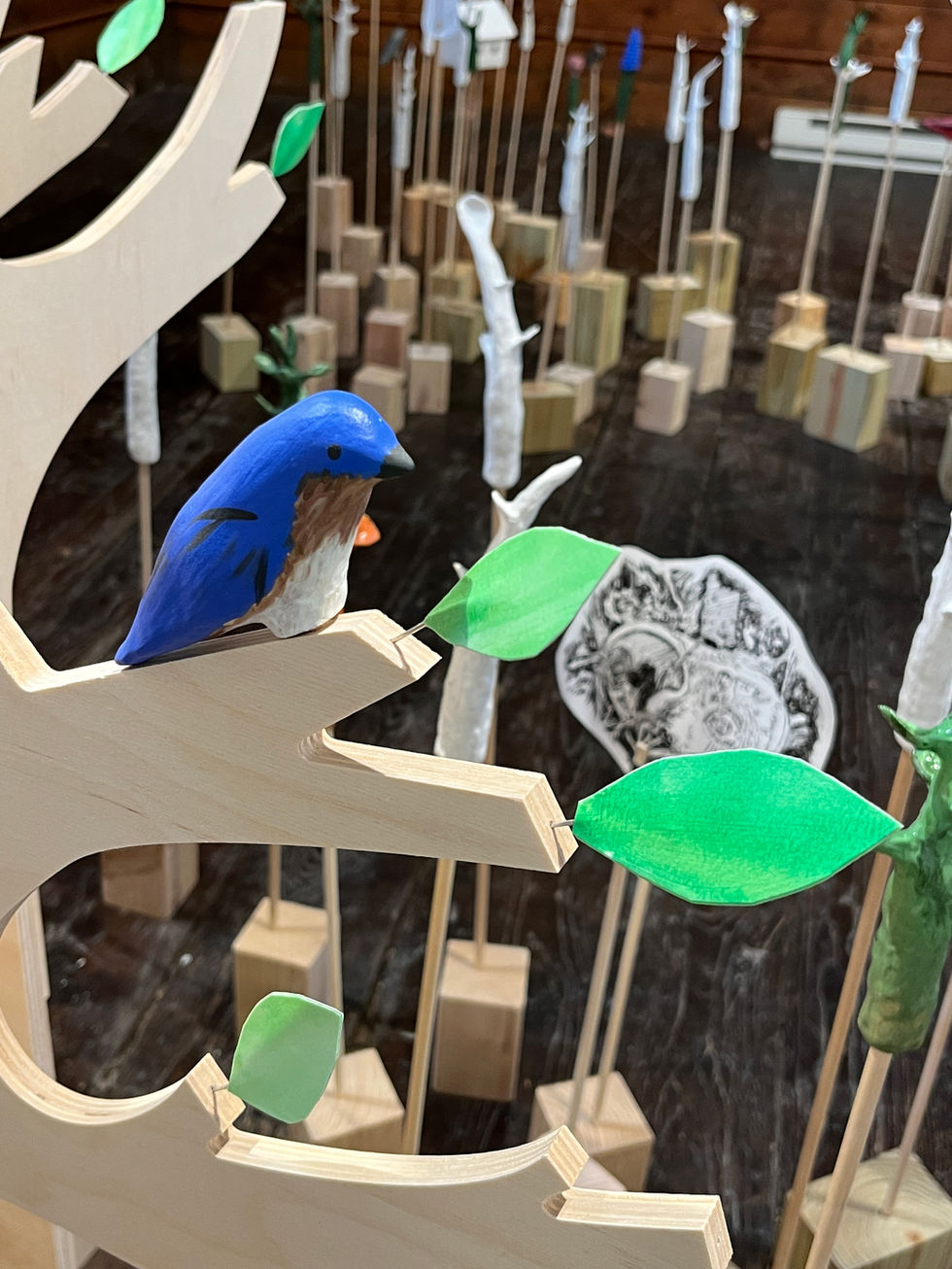 Installation detail with plywood branch, paper leaves and ceramic bluebird