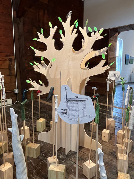 Sculpture installation detail with plywood tree, paper leaves and drawings