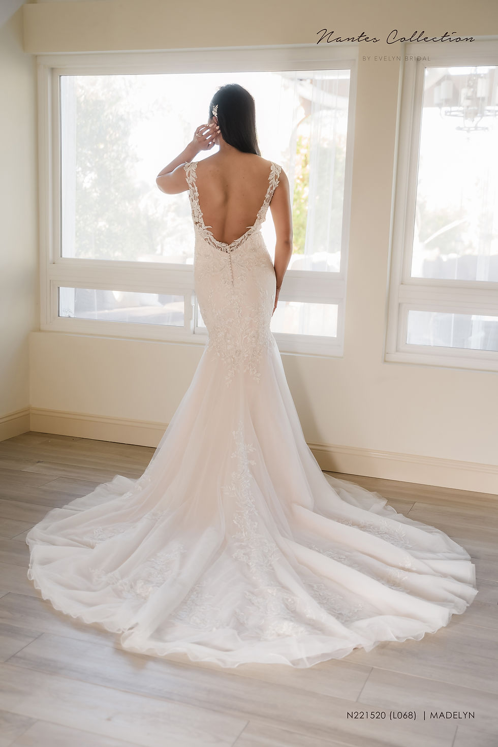 Thumbnail: MADELYN | N221520
Gown Info
Elegant lace and tulle mermaid wedding dress. The bodice features a deep V-neckline, delicate lace straps, and low scoop illusion back. The skirt flares out mid-thigh with cascading lace appliques and a chapel length train.

Material
Lace

Tulle 

 

Color & Size
Ivory/Nude (Shown)

Ivory/Ivory

Sizes available in 2-28  / 14W-32W