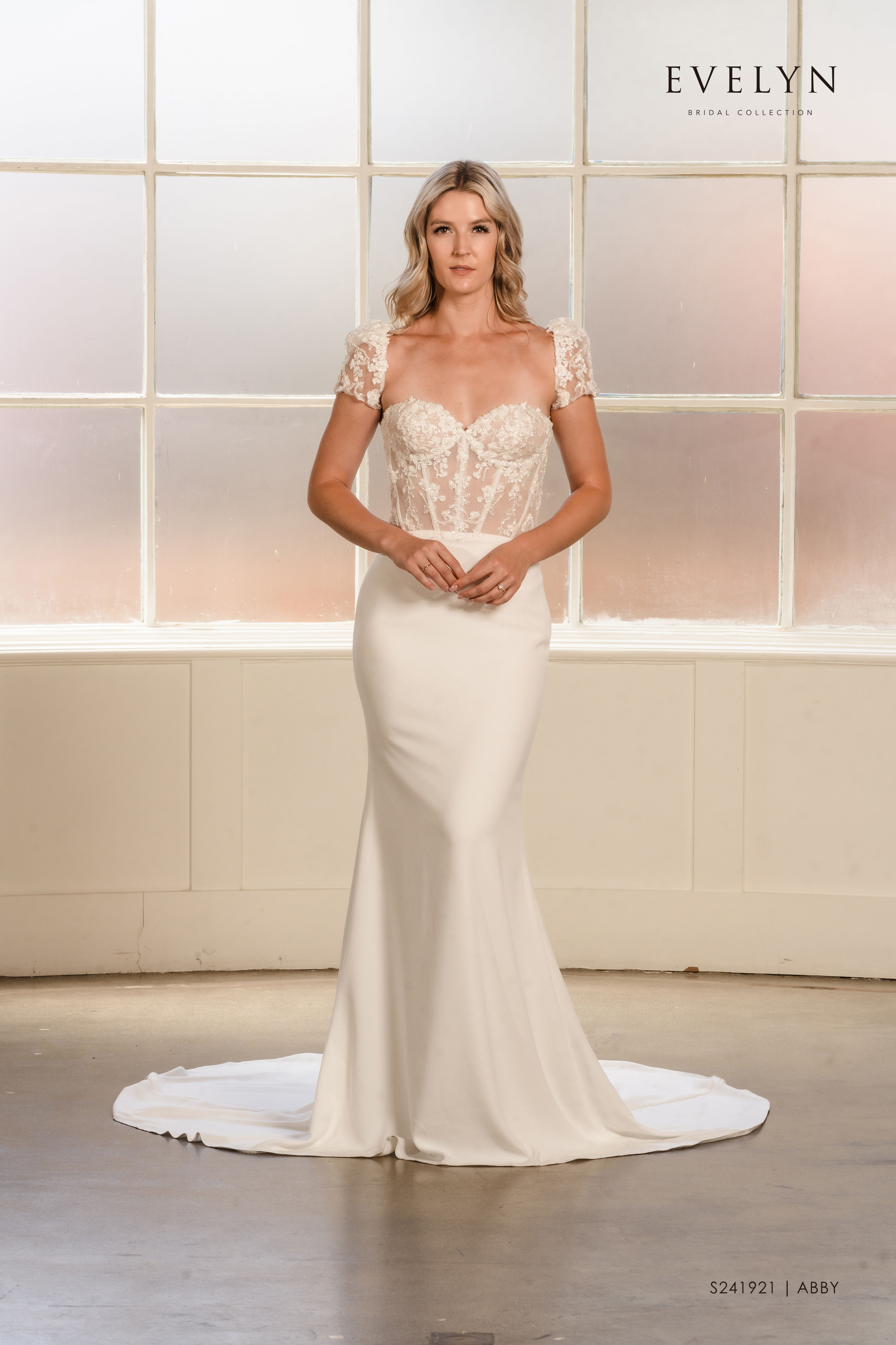 Abby | S241921
Gown Info
Available with or without sleeves

Step into a world of timeless elegance with this breathtaking wedding dress. The sweetheart neckline and flowing crepe mermaid skirt effortlessly enhance your silhouette. The sheer lace upper body, adorned with intricate beadwork and structured boning, adds an irresistible allure. Complete with removable sleeves featuring dazzling bead accents, this gown offers versatility and enchantment. Embrace sophistication and create unforgettable moments on your special day with this extraordinary dress.

Material
Crepe

Color & Size
Shown in Ivory/Nude

Also available in Ivory/Ivory

Available Sizes: 2 - 28 / 14W - 32W Size Chart