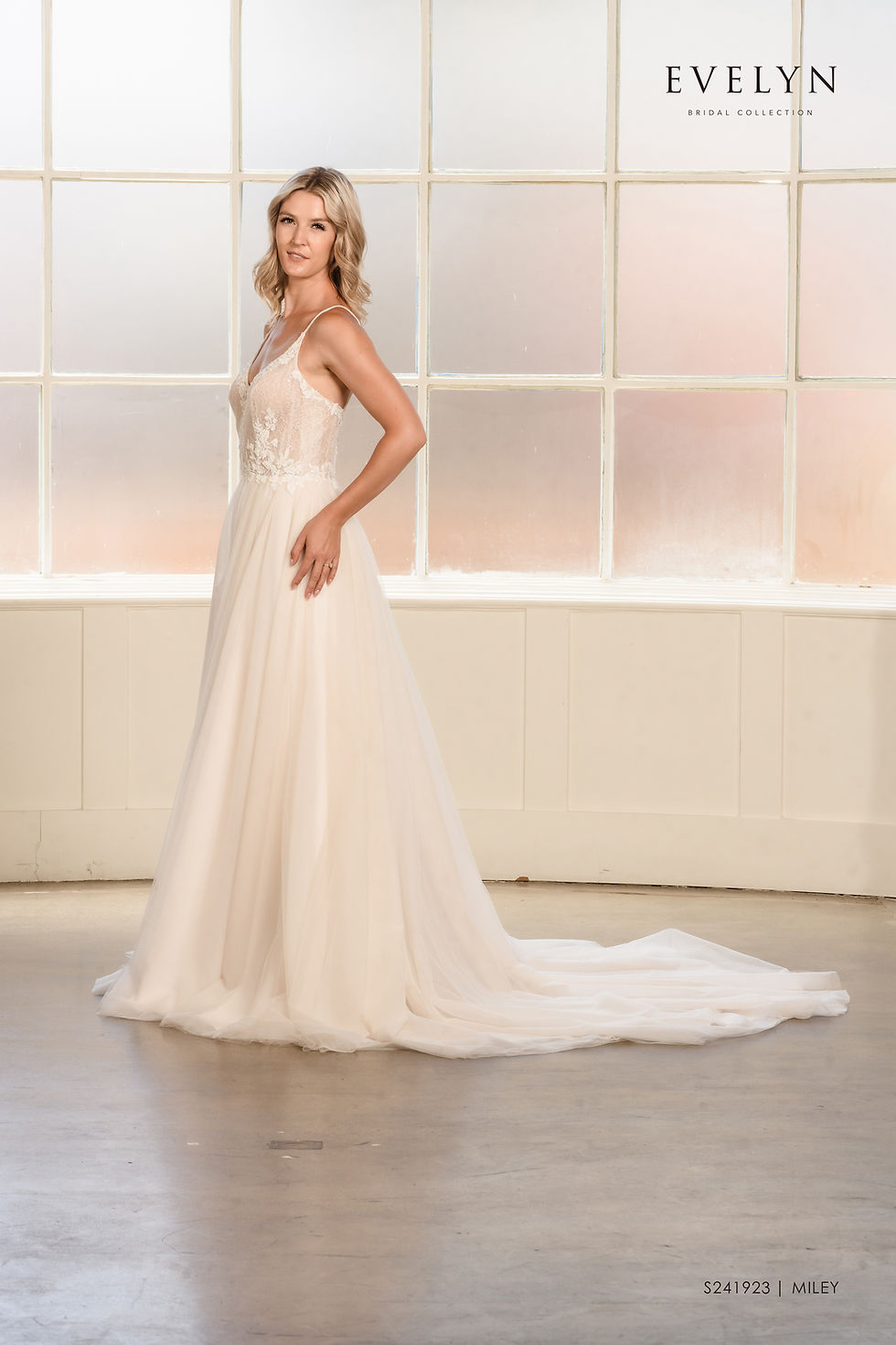 Thumbnail: Miley | S241923
Gown Info
Step into a world of enchantment with this captivating wedding dress. The low neckline exudes elegance, while the delicate tulle skirt adds a touch of whimsy and movement. The upper body showcases intricate lace appliques, carefully placed on the patterned tulle fabric that adorns both the bodice and neckline. Shimmering beadwork enhances the shoulder straps, adding a glamorous sparkle. For ease of wear, the dress is thoughtfully designed with a discreet back zipper closure. Embrace the allure of this extraordinary gown as you make your grand entrance, radiating grace and timeless beauty on your special day.

Material
Tulle

Color & Size
Shown in Ivory/Nude

Also available in Ivory/Ivory

Available Sizes: 2 - 28 / 14W - 32W Size Chart