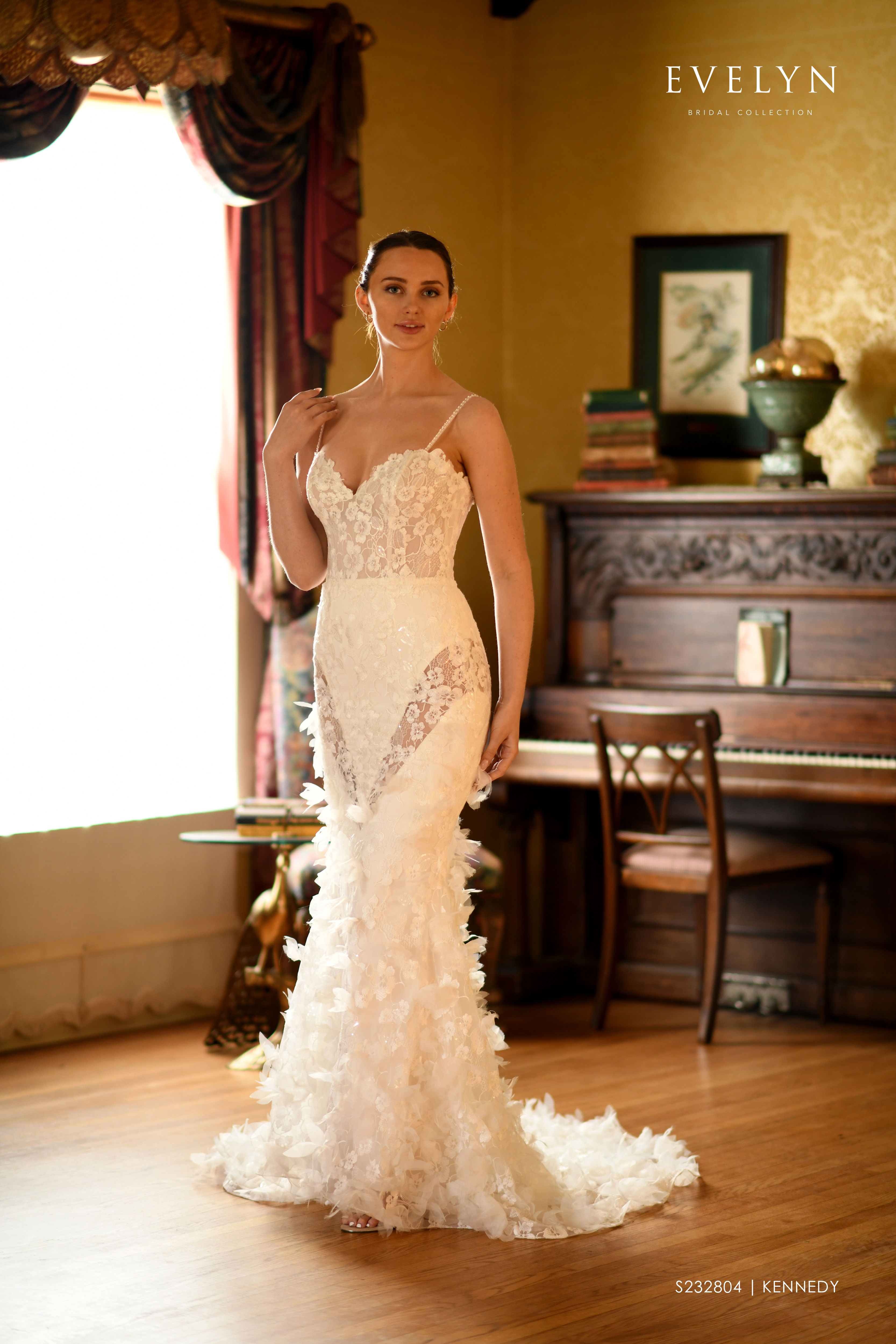 Kennedy | S232804
Gown Info
Crafted from soft tulle fabric, this wedding dress boasts a dreamy style with a delicate neckline supported by thin beaded straps, adding a touch of sophistication to the overall design. The top and skirt are adorned with intricate over lace and shimmering embellishments, creating a romantic and ethereal feel. The skirt features sheer lace from the thigh to the knee, overlaid with lace on the top layer, adding a touch of mystery and sensuality to the dress. Tulle petal-like shapes sewn onto the lace create a subtle and elegant movement, adding a whimsical touch to this enchanting dress. This dress is a perfect choice for any bride seeking a unique and magical wedding gown.

Material
Tulle/Lace

Color & Size
Shown in Ivory/Champage

Also available in Ivory/Ivory

Available Sizes: 2 - 28 / 14W - 32