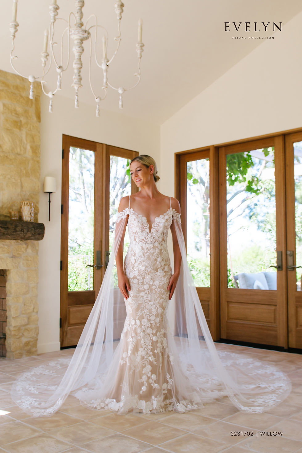 Thumbnail: Willow | S231702
Gown Info
Off the shoulder lace straps with a long sleeve cape makes for a stunning and unique silhouette in our Willow gown. The delicate beaded spaghetti straps and deep V neckline lined with lace applique are perfect for the fashion forward bride. This lace and tulle fitted gown is both feminine and bold with its low V back neckline and court length train. We picture this beauty flowing with the wind at sunset!

Material
Lace/Tulle

Color & Size
Ivory/Nude

Ivory/Ivory

Sizes available - 2-28 / 14W-32W