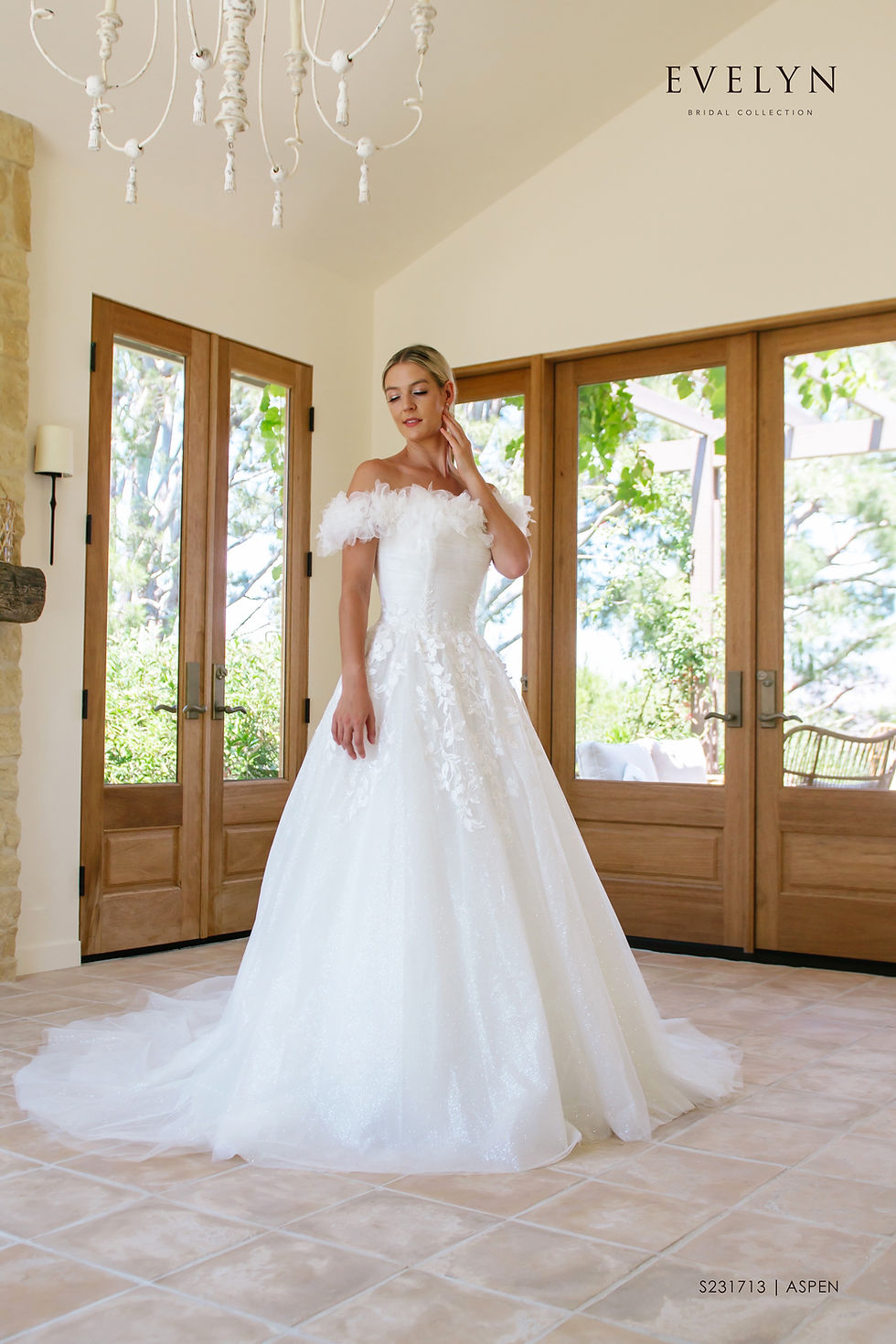 Thumbnail: Aspen | S231713
Gown Info
Off the shoulder ruffle sleeves lend romance and style to this tulle and lace ball gown. Aspen features a pleated tulle bodice and cascading lace appliques on a sparkle tulle skirt. A chapel length train completes this romantic dress.

Material
Tulle/Lace

 

Color & Size
Ivory
