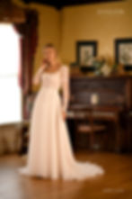 Thumbnail: Layne | S232815
Gown Info
Available with or without sleeves

Get ready to stun on your big day with our breathtaking tullesquare neckline wedding dress. The small flared skirt and intricate lace ruffles create a playful yet sophisticated look, while the diagonal stripes on the upper body and chest add a touch of contemporary flair. Delicate beads and shimmering sequins embellish the lace ruffles, and the 3D embroidered flowers on the upper body are simply breathtaking. The back of the dress features a button closure and a long-sleeved tulle top with lace ruffles and sequins on the sleeves. The button closures at the cuffs and back of the upper body ensure a comfortable and secure fit throughout your special day. With this enchanting and romantic wedding dress, you'll feel like the most beautiful and radiant bride.

Material
Tulle/Lace

Color & Size
Shown in Ivory/Pearl

Also available in Ivory/Ivory

Available Sizes: 2 - 28 / 14W - 32W