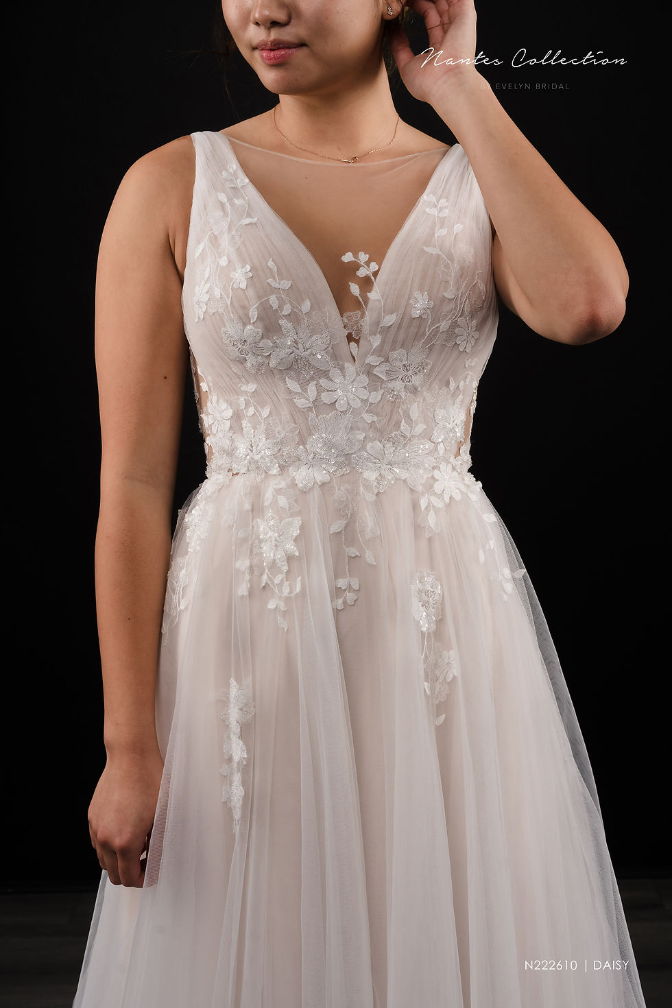 Thumbnail: DAISY | N222610
Gown Info
For the utterly romantic, this light and airy tulle A-line gown features a soft tulle bodice and delicate lace embellishments. A low back and an impressive tulle skirt with a chic chapel length train complete the stunning look!

Material
Tulle

Color & Size
Ivory/Pink (Shown)

Ivory/Champange

 

Sizes available - 2-28  / 14W-32W