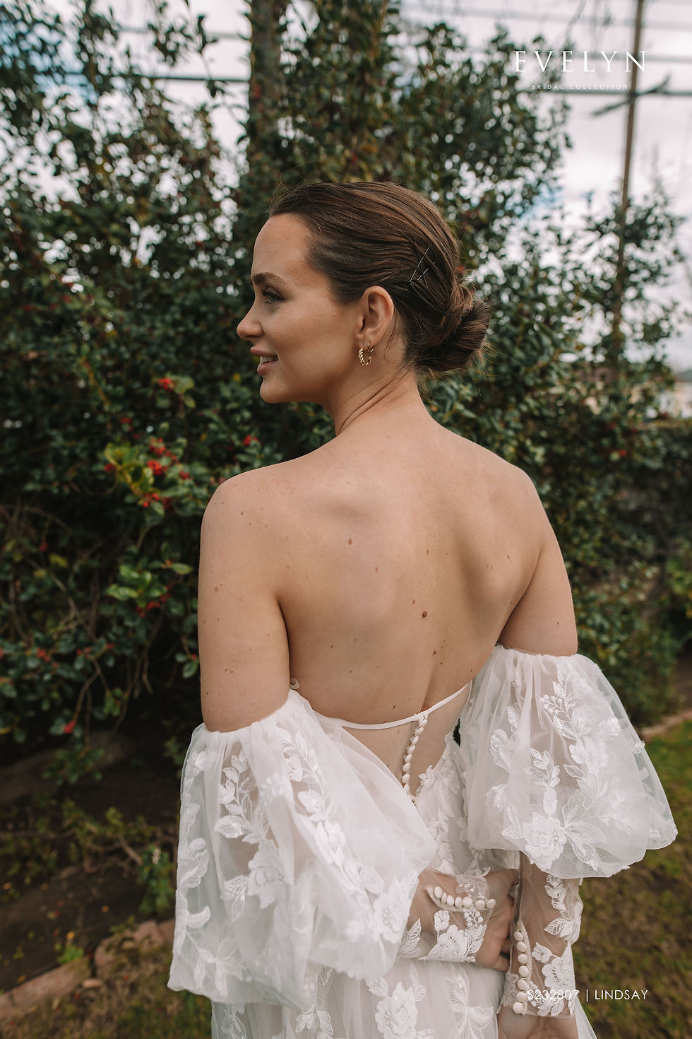 Thumbnail: indsay | S232807
Gown Info
Available with our without sleeves

Discover the dreamy and ethereal quality of our tulle wedding dress with a sweetheart neckline. The upper bodice boasts delicate flat lace, cotton lace, and shimmering sequins that beautifully catch the light. Short puffy sleeves made of sheer fabric create an airy and whimsical effect, adorned with intricate flat lace, cotton lace, and sparkling sequins for an added touch of magic. The wide skirt features a high slit on the left side, adding a playful touch and revealing a glimpse of the wearer's leg as they move. The back of the dress is secured with dainty buttons, completing the enchanting and dreamy look. Allow yourself to be enchanted by the romantic and ethereal charm of this stunning wedding dress.

Material
Tulle/Lace

Color & Size
Shown in Ivory/Light Pink

Also available in Ivory/Ivory

Available Sizes: 2 - 28 / 14W - 32W