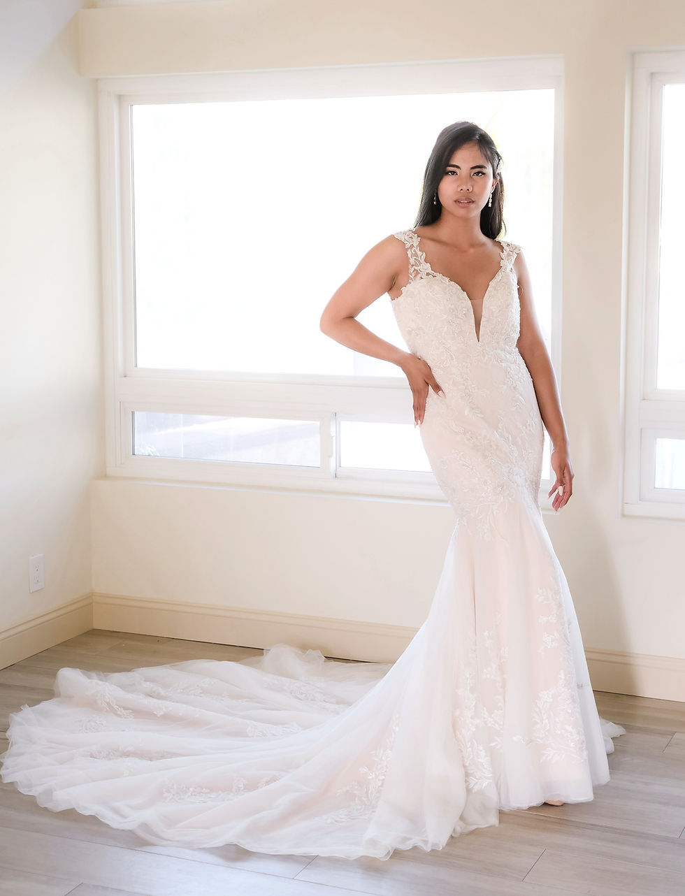 MADELYN | N221520
Gown Info
Elegant lace and tulle mermaid wedding dress. The bodice features a deep V-neckline, delicate lace straps, and low scoop illusion back. The skirt flares out mid-thigh with cascading lace appliques and a chapel length train.
Material
Lace
Tulle
Color & Size
Ivory/Nude (Shown)
Ivory/Ivory
Sizes available in 2-28 / 14W-32W