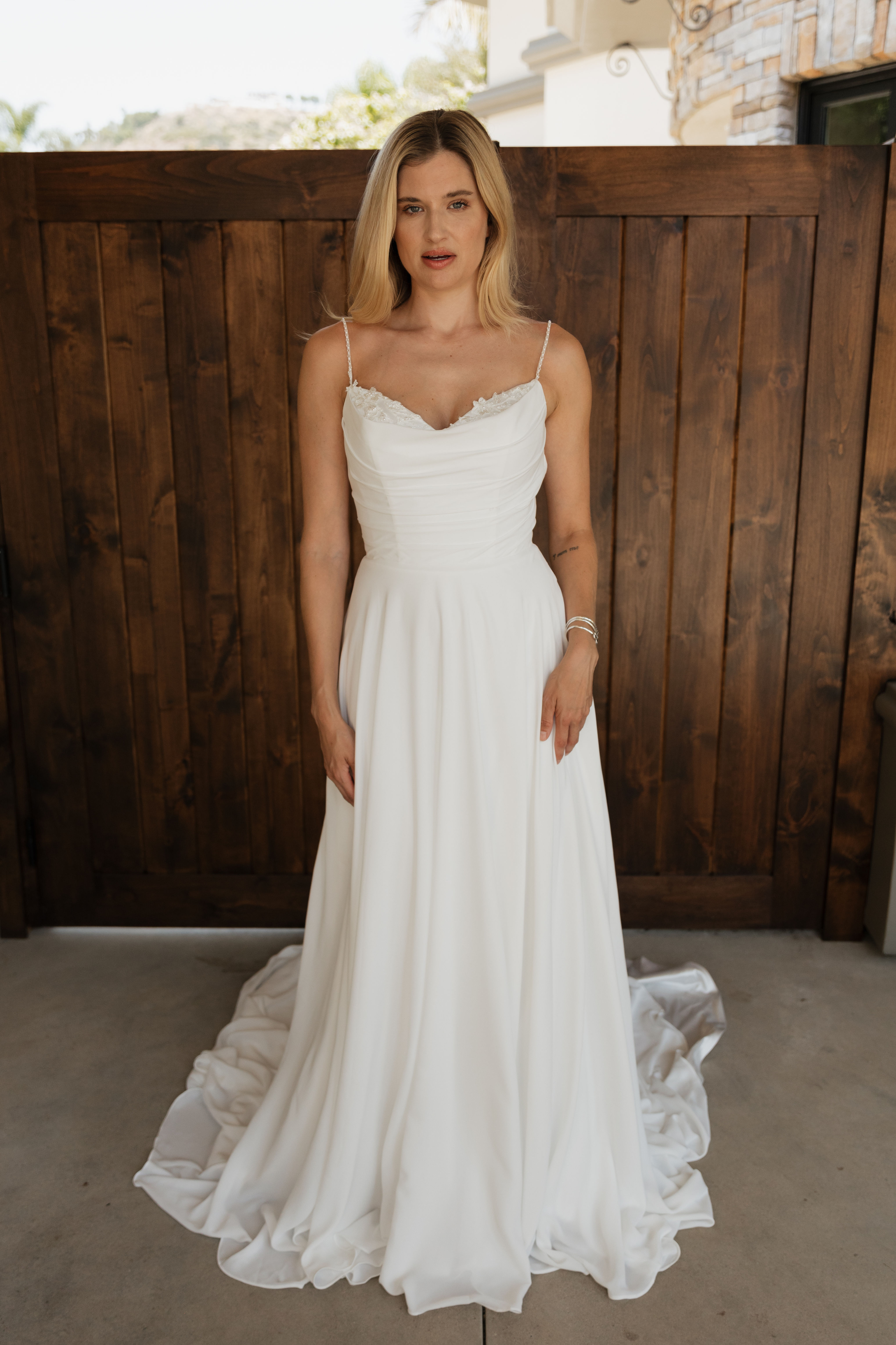 Sophia | N25523
Gown Info
Step into a world of elegance with this captivating gown, designed to exude romance and allure. The upper body features luxurious satin, expertly interlined and lined for a flawless, sculpted fit that accentuates your natural curves. The lower skirt enchants with its delicate layers of chiffon over satin, also interlined for a smooth, flowing silhouette. Perfect for creating unforgettable moments, this gown ensures you feel irresistibly beautiful and enchanting.
Material
Satin/Chiffon
Color & Size
Available in Ivory/Ivory
Available Sizes: 2 - 28 / 14W - 32W Size Chart