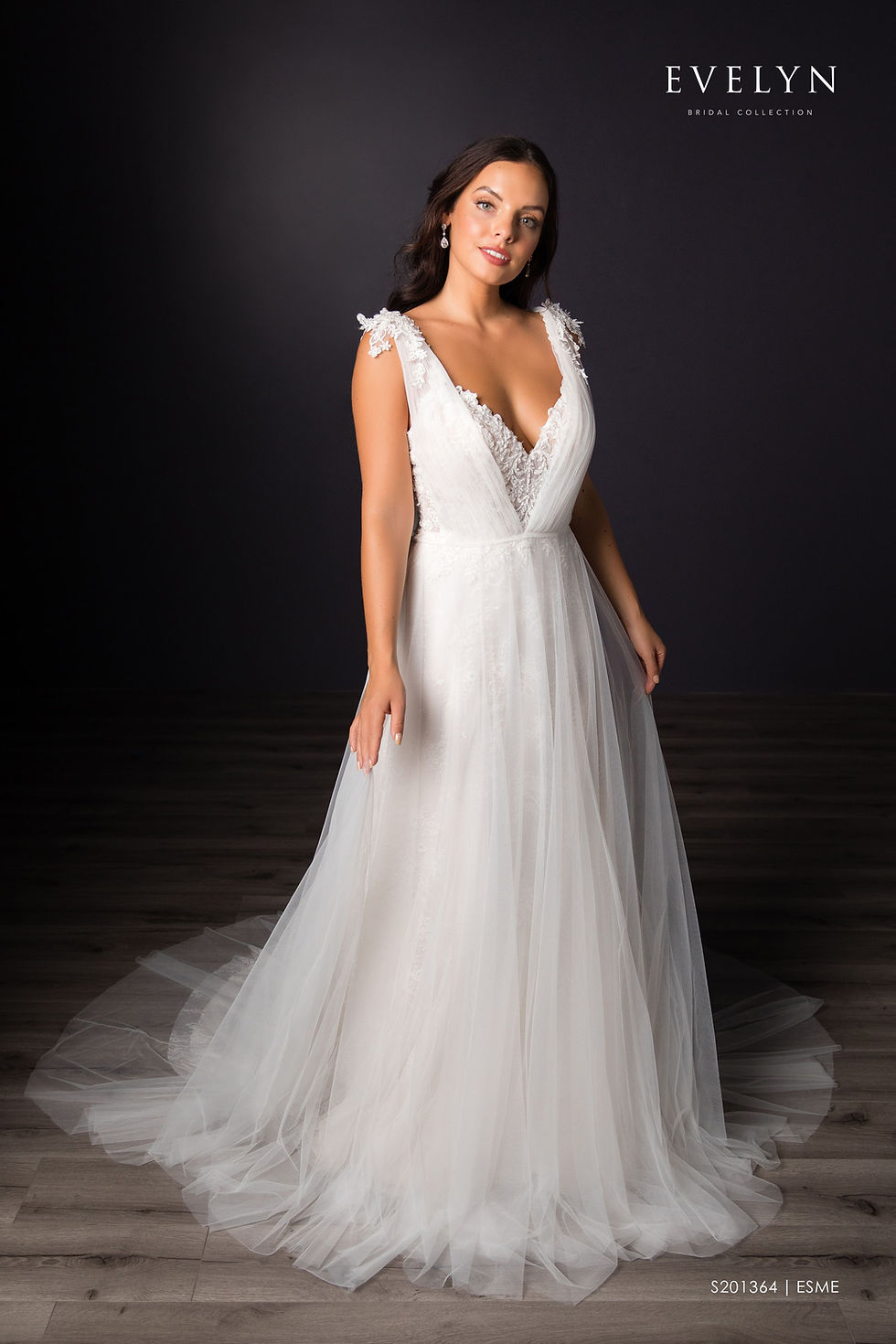 Thumbnail: Esme | S201364
Gown Info
Charming tulle and lace A-line gown with tulle topper. The bodice features a V neckline and lace embellished thin straps while the allover lace skirt fans out to a court length train. The dress can be worn with an elegant ruched tulle V-neck topper with lace embellishement at the shoulder.

Material
Lace

Tulle

 

Color & Size
Ivory/Nude/Ivory (Shown)

Ivory/Ivory

 

Sizes available in 2-28  / 14W-32W