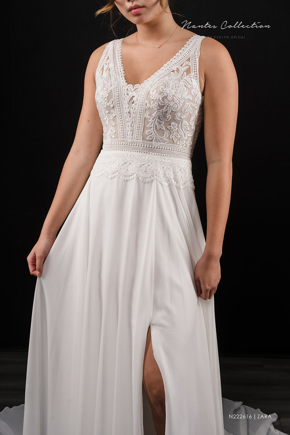 Thumbnail: Our Zara gown features stunning doily lace accents and an A-line chiffon skirt. 

ZARA | N222616
Gown Info
Make jaws drop in our Zara Gown! Doily lace is the star of show as it embellishes the neckline and belt. A stunning lace and chiffon A-line skirt ending in a court length train adds to the feminine and bold feel of this dress.

Material
Lace/Chiffon

Color & Size
Ivory/Champange (Shown)

Ivory

 

Sizes available - 2-28  / 14W-32W