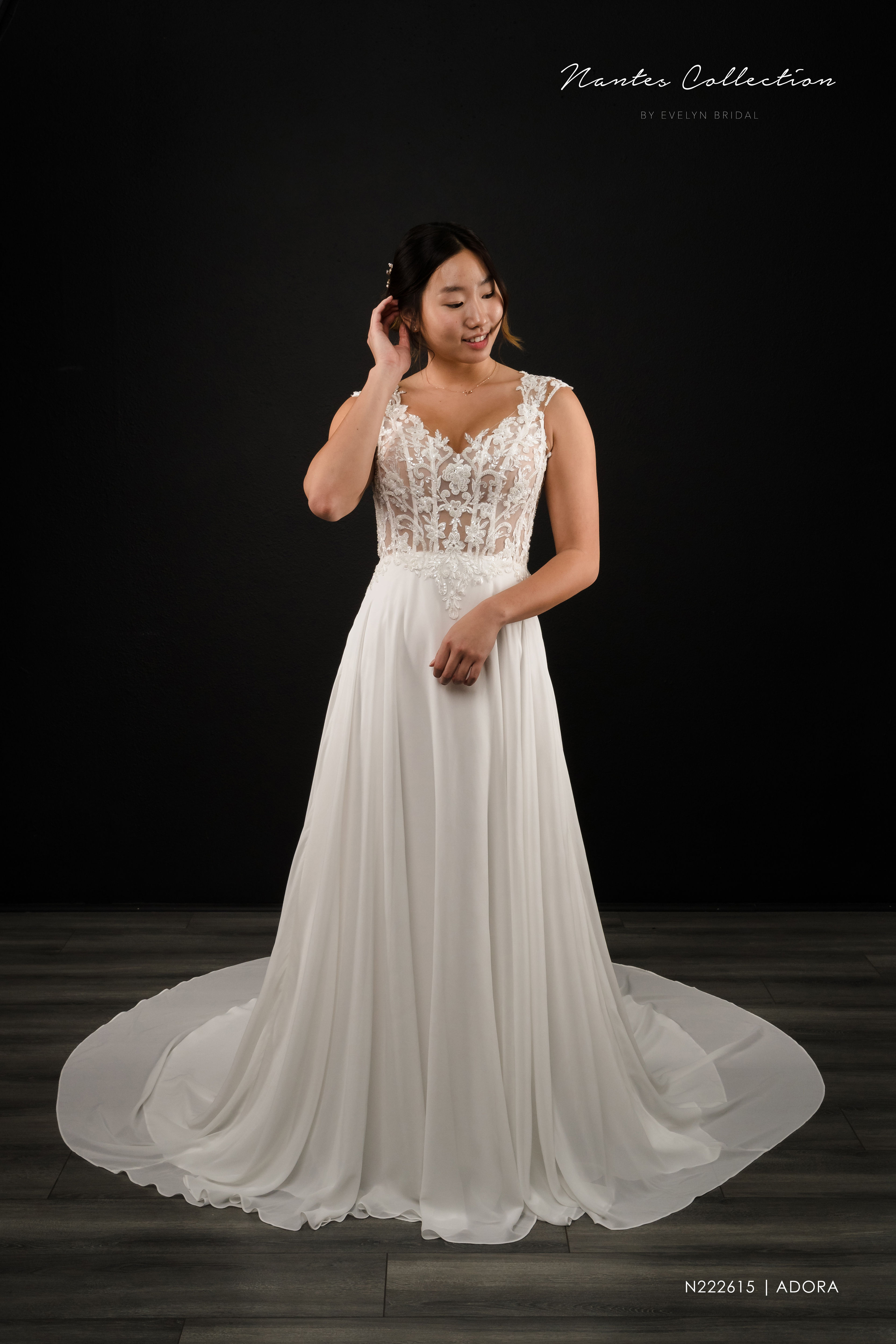 ADORA | N222615
Gown Info
A perfect classical look with modern details. The beaded lace bodice features dainty beaded cap sleeves and a V-neckline. A gorgeous deep V back and a chapel length train complete this elegant gown.

Material
Lace/Chiffon 

Color & Size
Ivory/Nude (Shown)

Ivory

 

Sizes available in 2-28  / 14W-32W