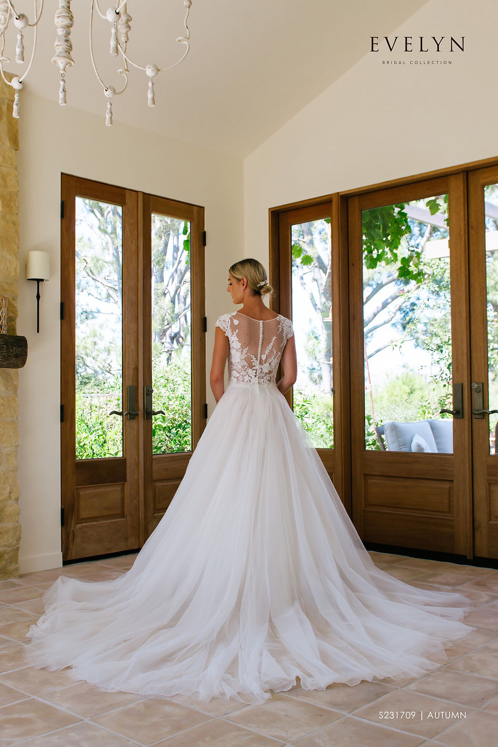 Autumn | S231709
Gown Info
Autumn exudes class and beauty. The illusion V neckline with dot over lace and cap sleeves with asymmetrical lace on the shoulder accentuate this lace and tulle ball gown. A dainty lace belt highlights the bride’s waist. Autumn boasts a soft sweeping skirt with a chapel length train. The illusion back neckline with cover button sleeves finishes off this perfect gown.

Material
Lace/Tulle

Color & Size
Ivory/Ivory

Sizes available - 2-28 / 14W-32W