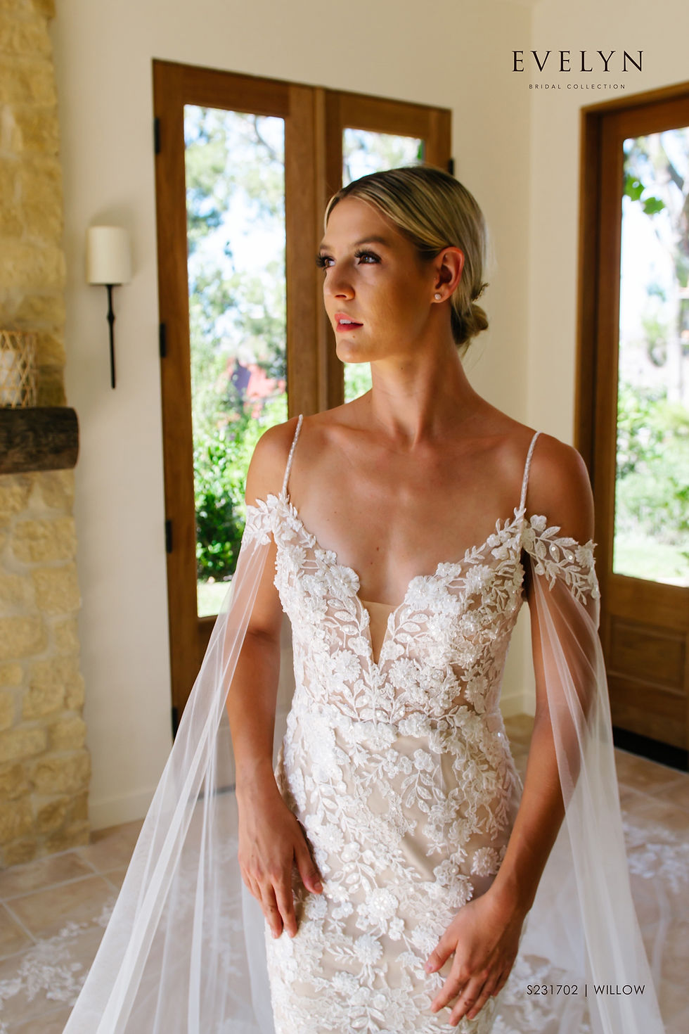 Thumbnail: Willow | S231702
Gown Info
Off the shoulder lace straps with a long sleeve cape makes for a stunning and unique silhouette in our Willow gown. The delicate beaded spaghetti straps and deep V neckline lined with lace applique are perfect for the fashion forward bride. This lace and tulle fitted gown is both feminine and bold with its low V back neckline and court length train. We picture this beauty flowing with the wind at sunset!

Material
Lace/Tulle

Color & Size
Ivory/Nude

Ivory/Ivory

Sizes available - 2-28 / 14W-32W