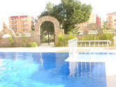 Swimming pool and arched gate at Rose Residence Oba