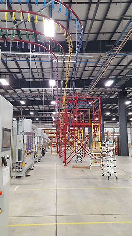 A hanger conveyor loaded with automotive parts