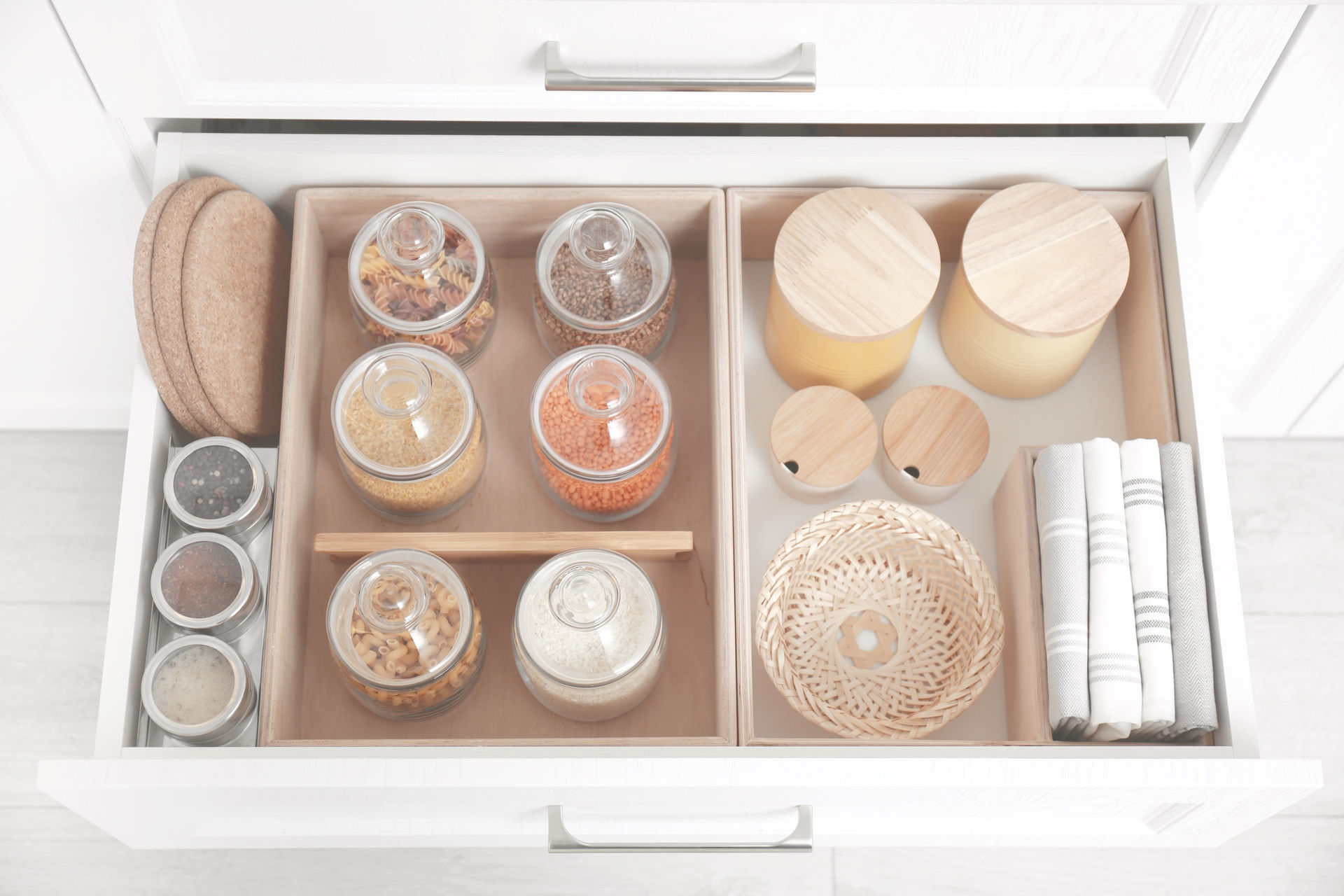Open drawer with different jars indoors. Order in kitchen.jpg